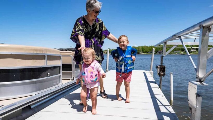 A family day on the lake walking on a floating dock