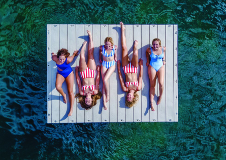 1000 Series Swim Platform floating dock with people sunbathing