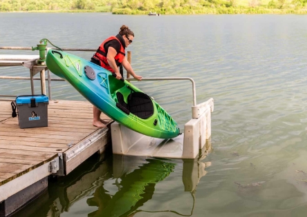 launching a kayak from a dock using a kayak launhc